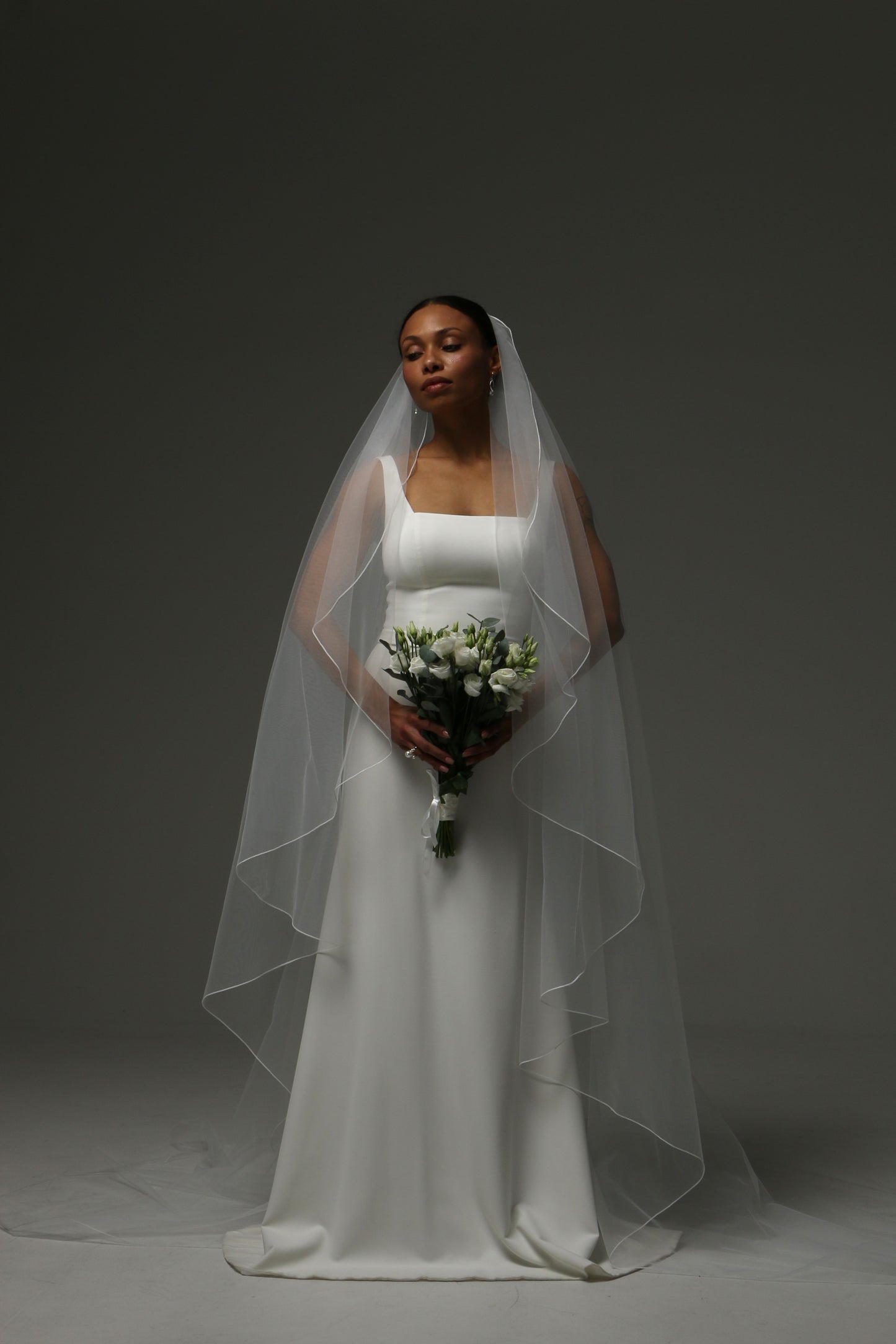Lightweight cathedral veil paired with a simple wedding gown.