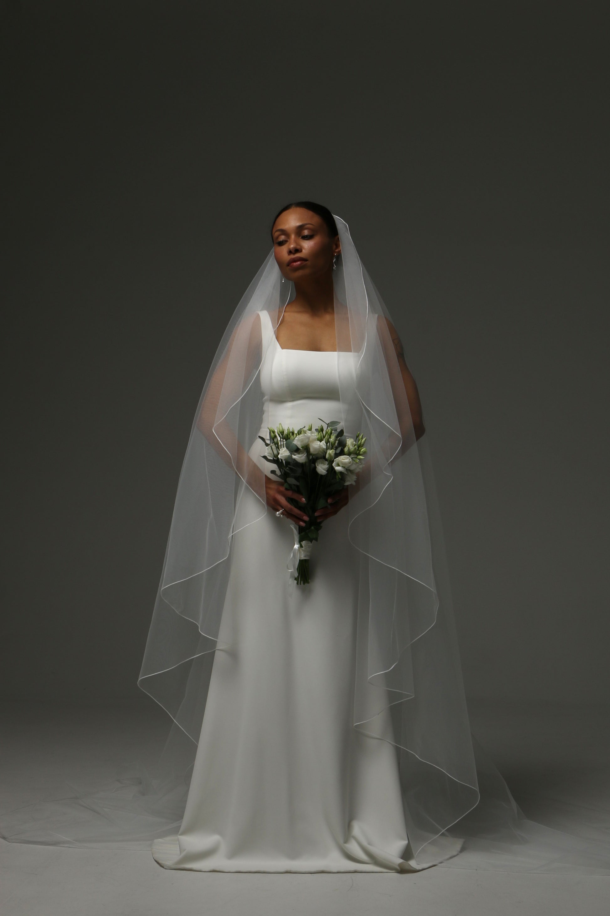 Lightweight cathedral veil paired with a simple wedding gown.