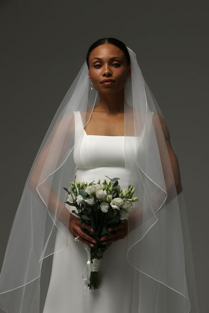 One-tier cascade cathedral wedding veil with delicate pencil edge finish.