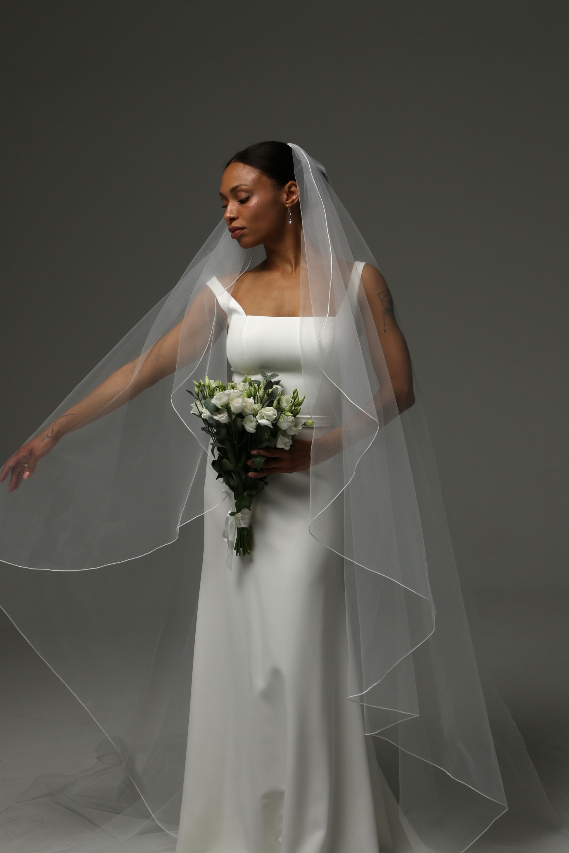Soft tulle wedding veil with refined edge finish.