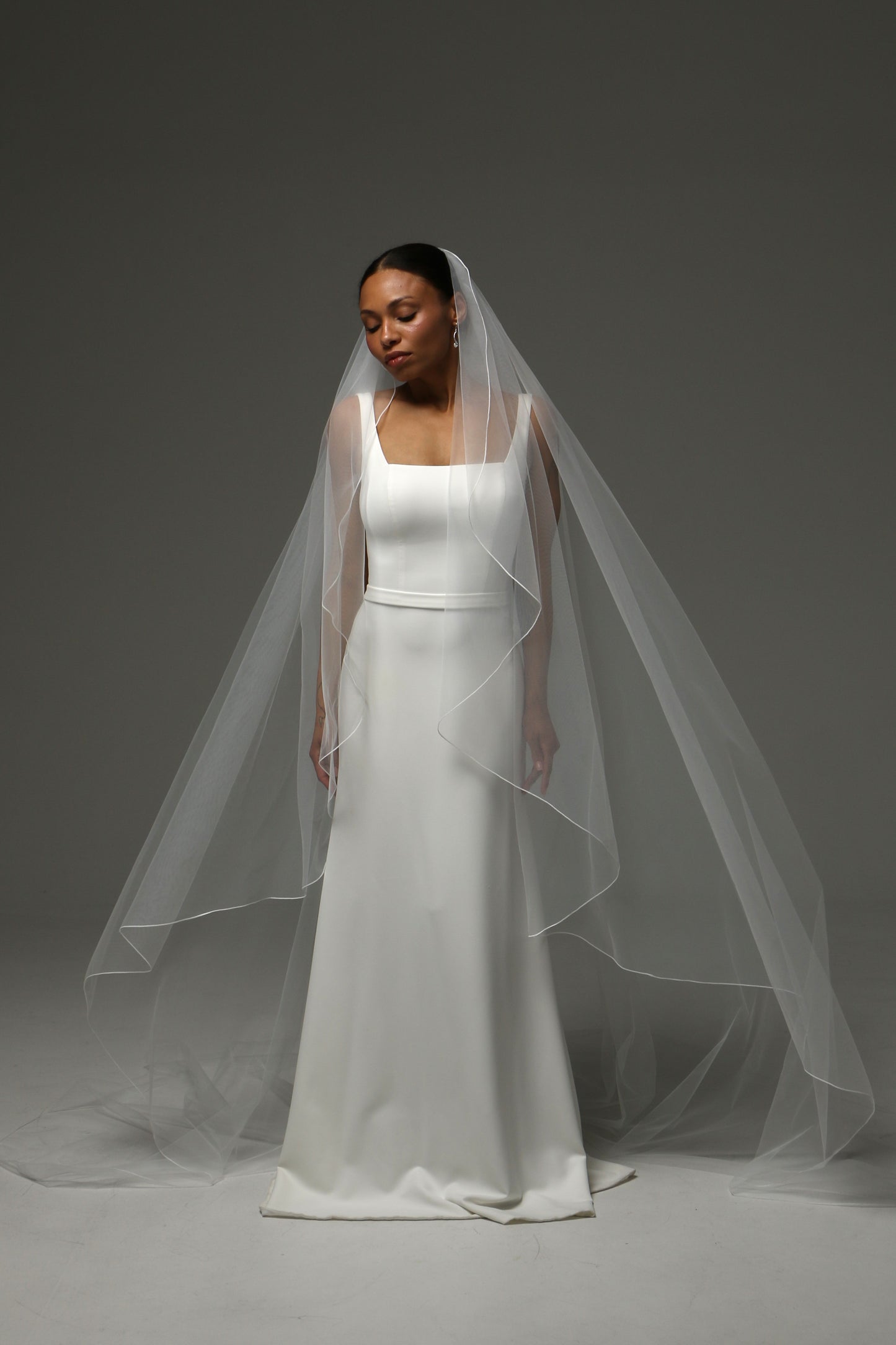 Contemporary cathedral veil with airy silhouette and natural movement.