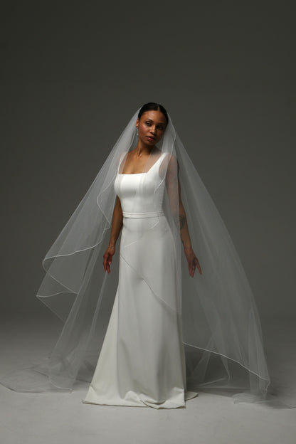 Handmade bridal veil featuring delicate pencil edge trim.