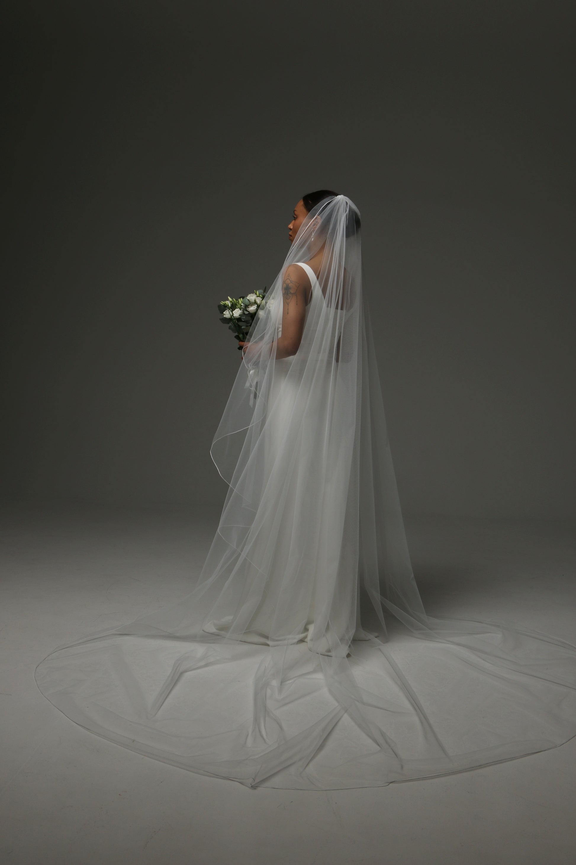 Minimalist wedding veil styled with a satin bridal dress.