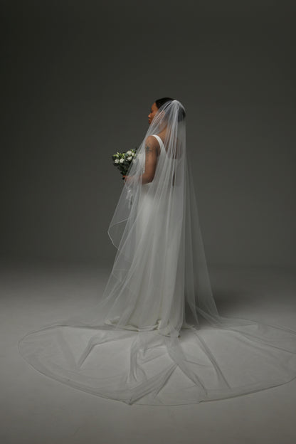 Minimalist wedding veil styled with a satin bridal dress.