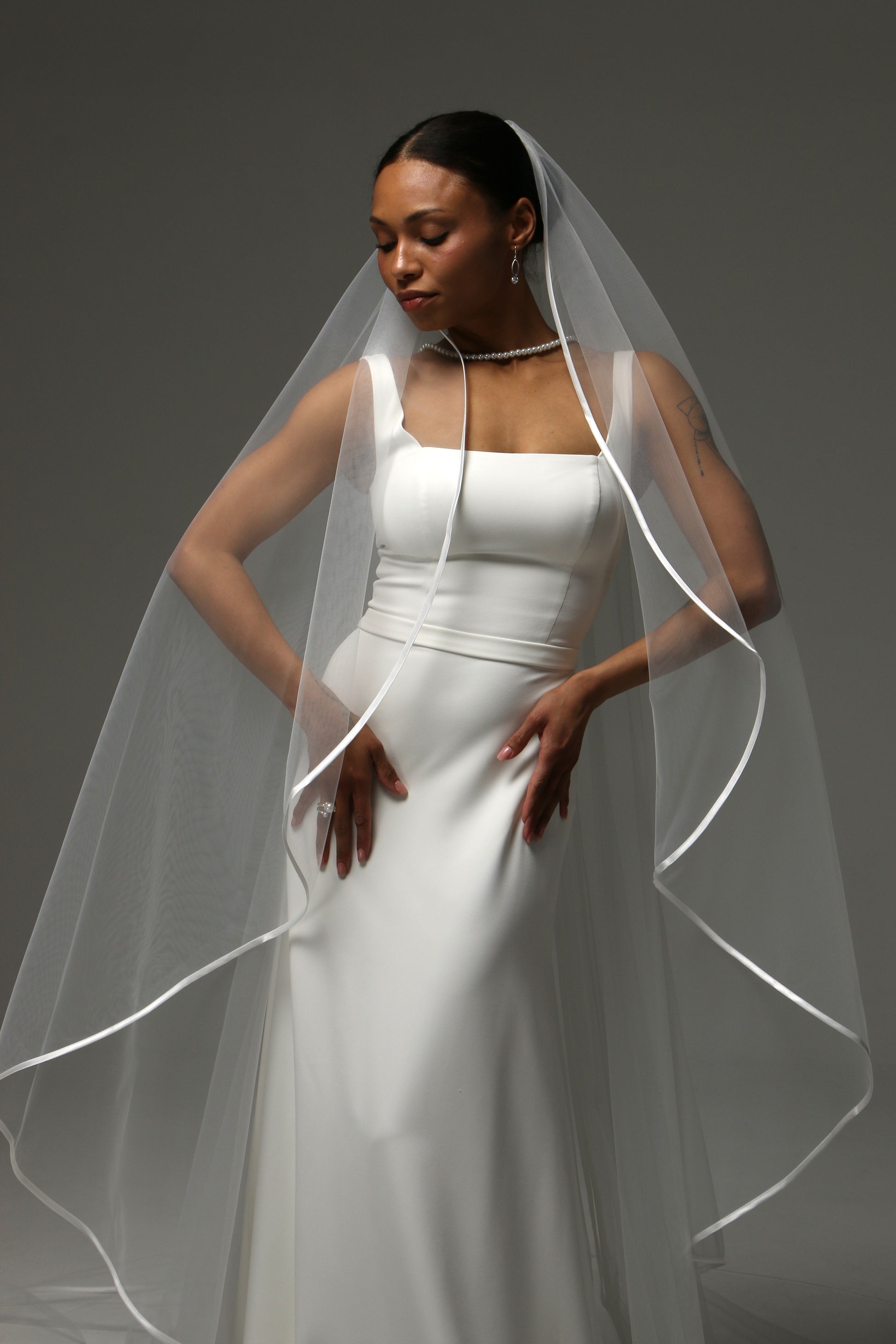 One-tier cascade cathedral wedding veil with satin ribbon edge.