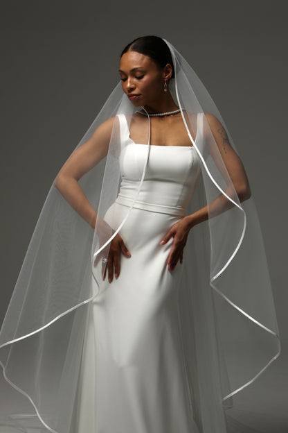 One-tier cascade cathedral wedding veil with satin ribbon edge.