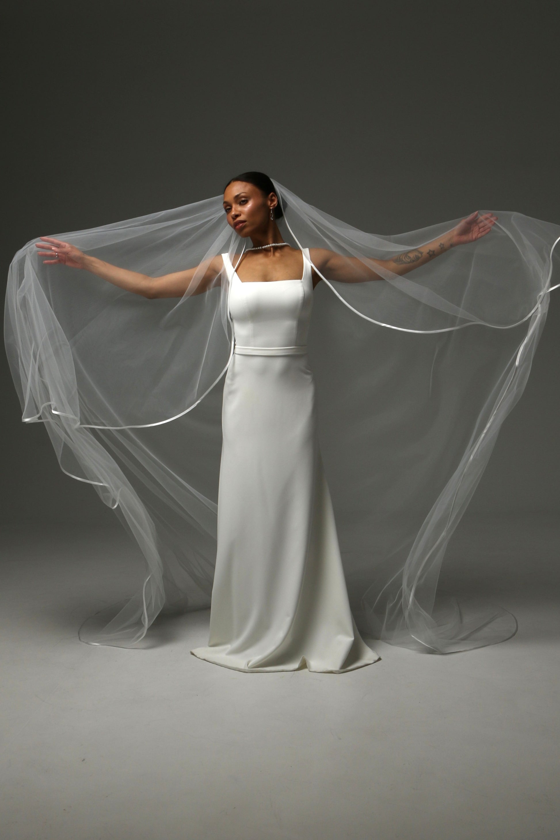 Modern cathedral veil with delicate satin ribbon detailing.