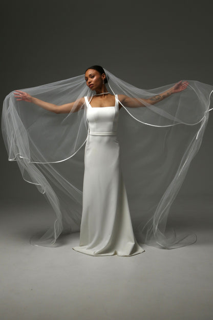 Modern cathedral veil with delicate satin ribbon detailing.