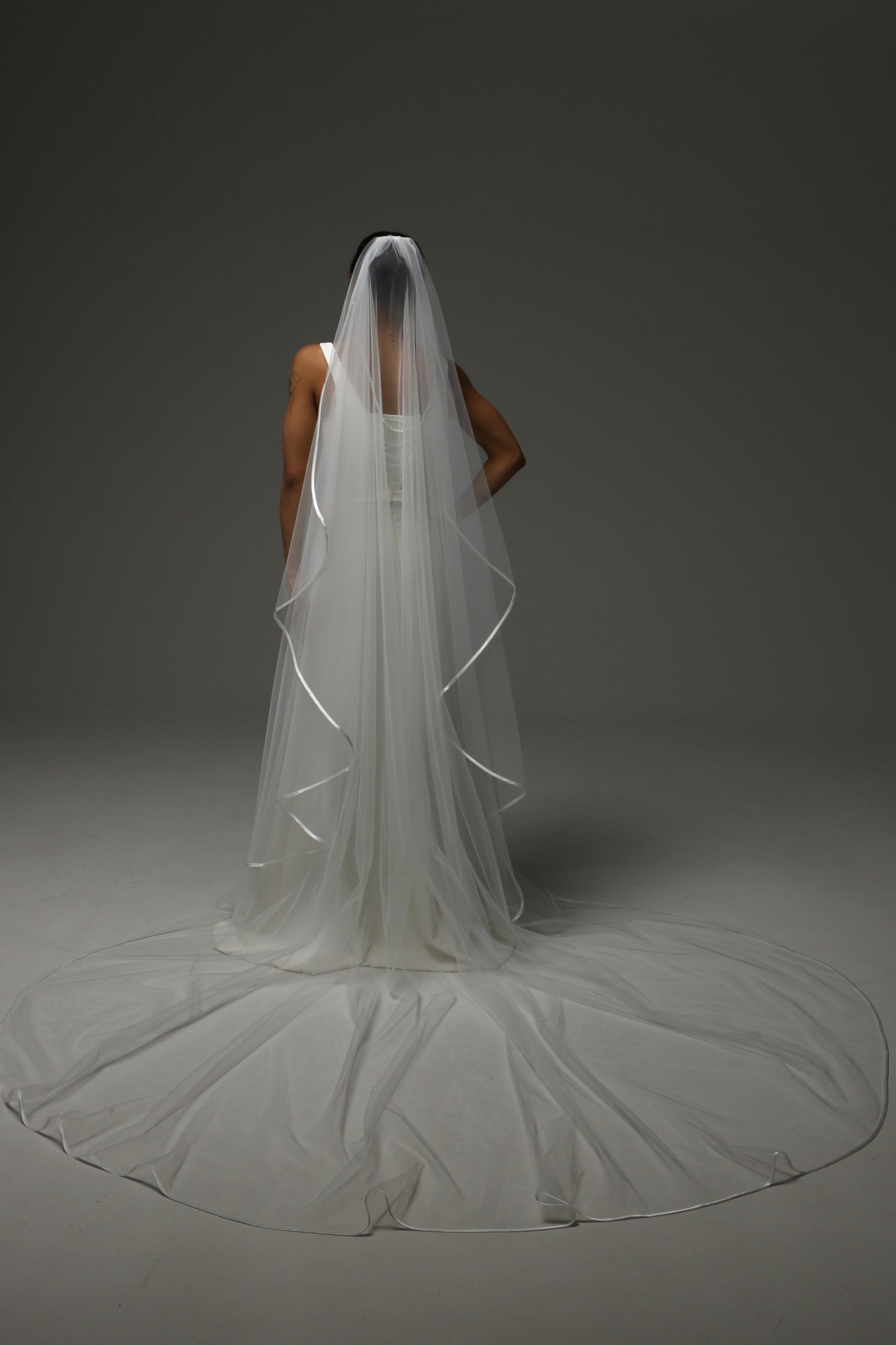Elegant bridal accessory with soft drape and satin trim.