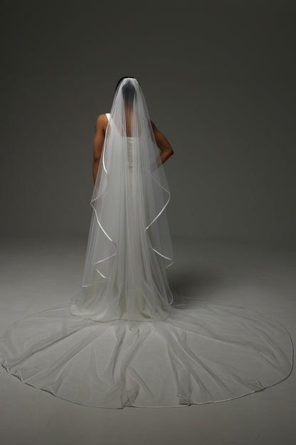 Elegant bridal accessory with soft drape and satin trim.