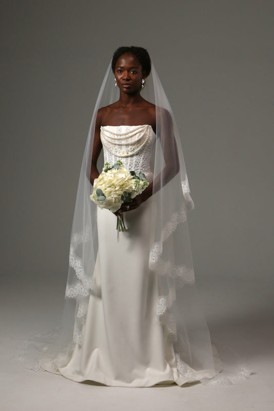 Two-tier cathedral wedding veil with delicate lace edge trim.