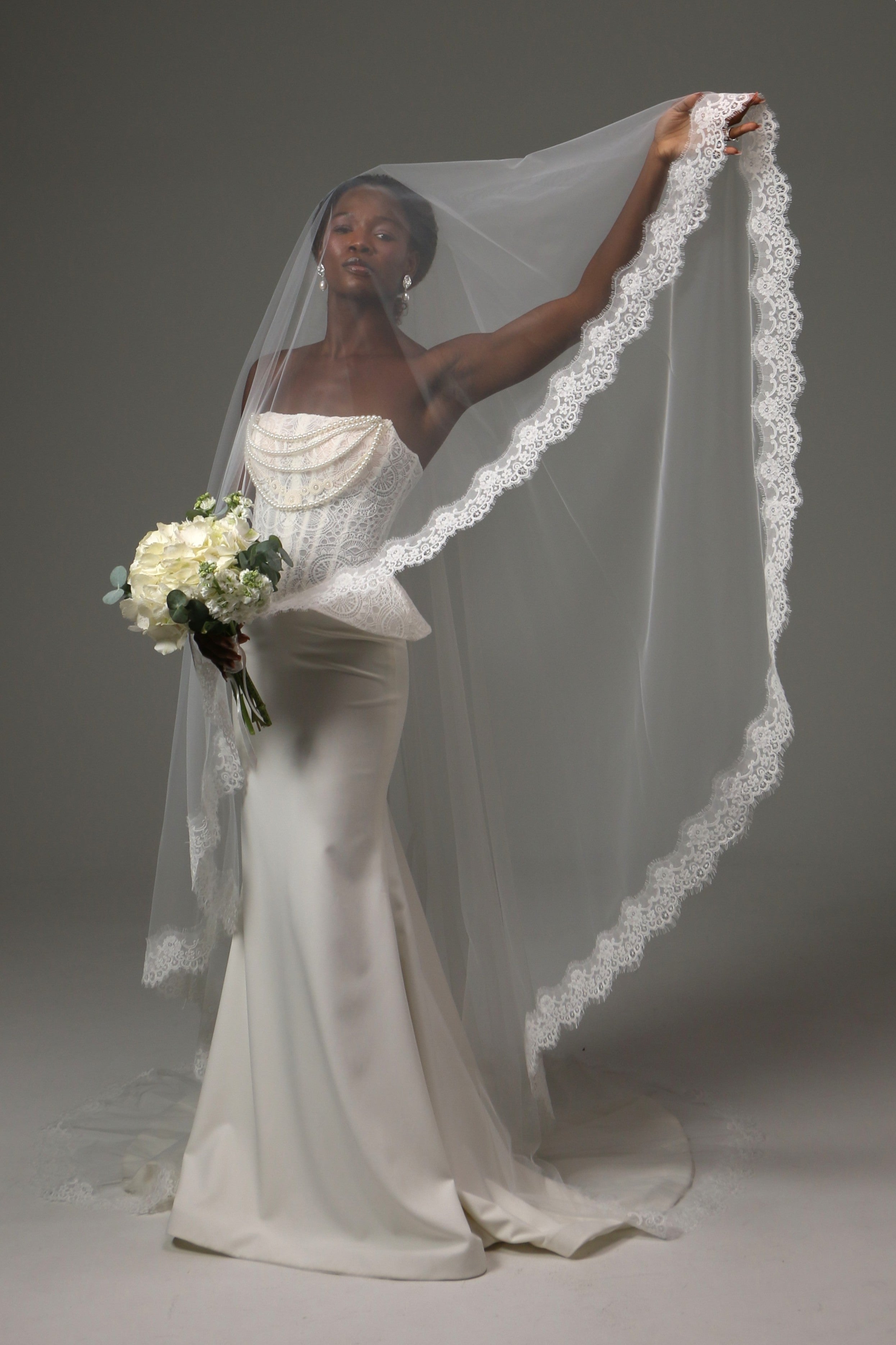 Bride wearing a cathedral-length veil crafted from soft illusion tulle.