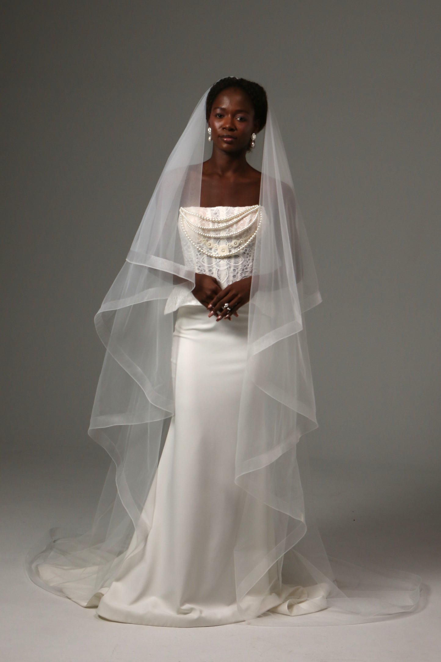 Two-tier cathedral wedding veil with horsehair edge and blusher.