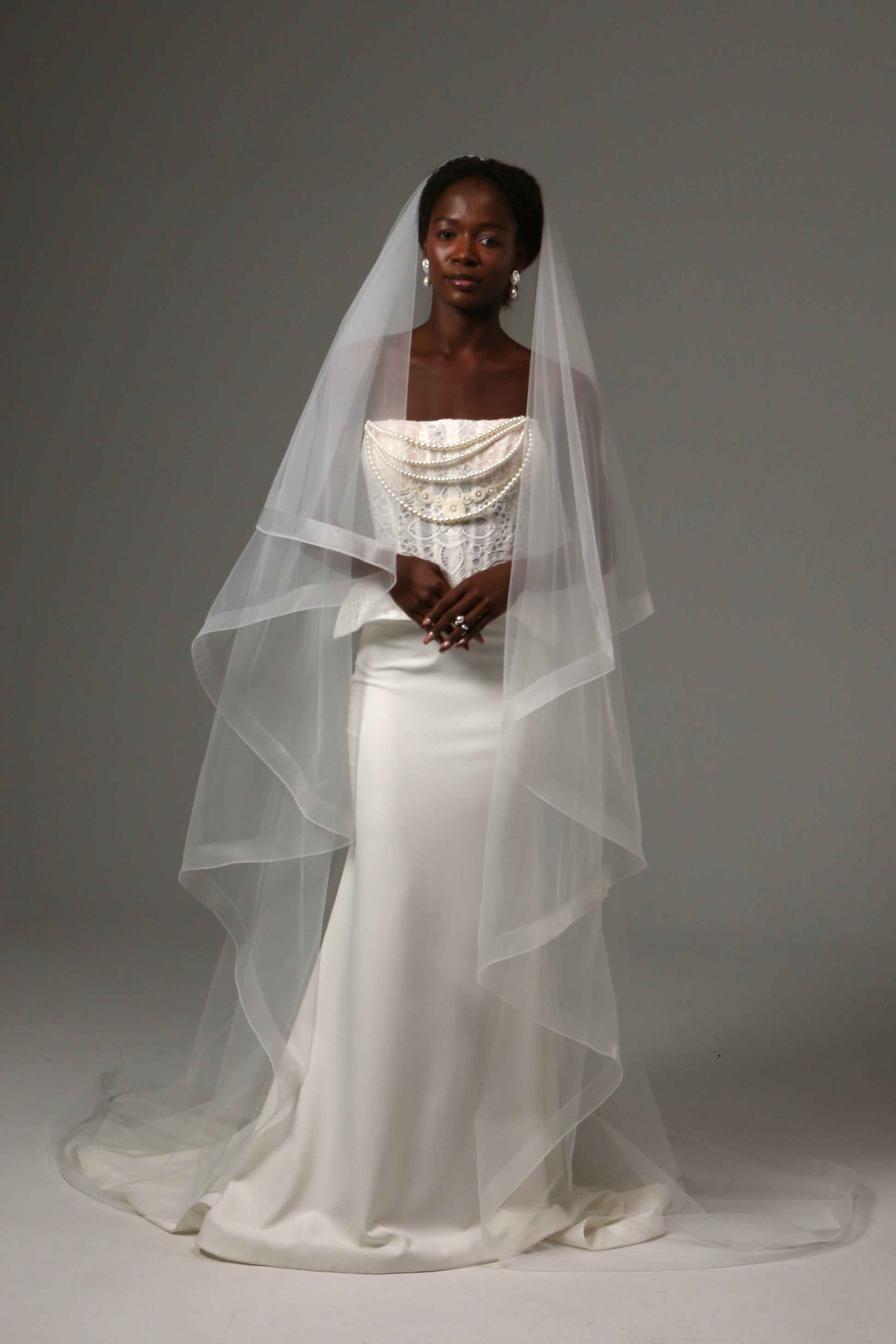 Two-tier cathedral wedding veil with horsehair edge and blusher.