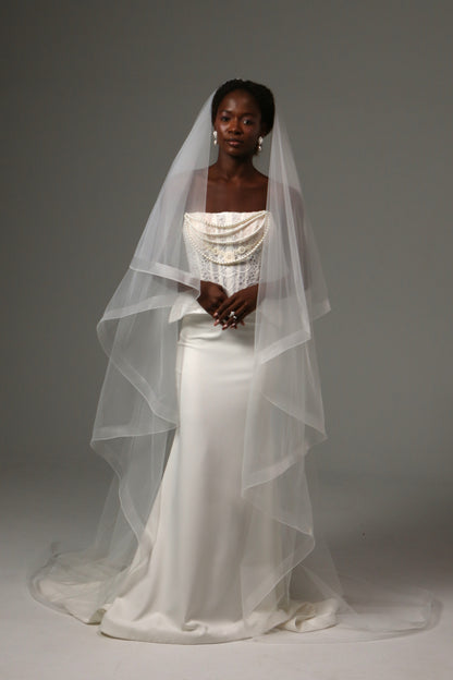 Two-tier cathedral wedding veil with horsehair edge and blusher.