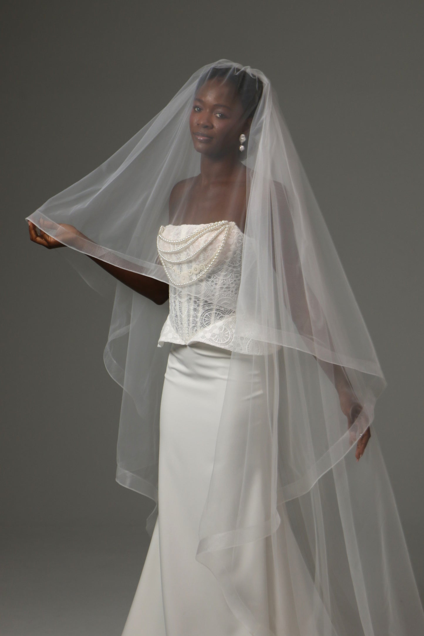 Cathedral-length wedding veil with elegant blusher layer.