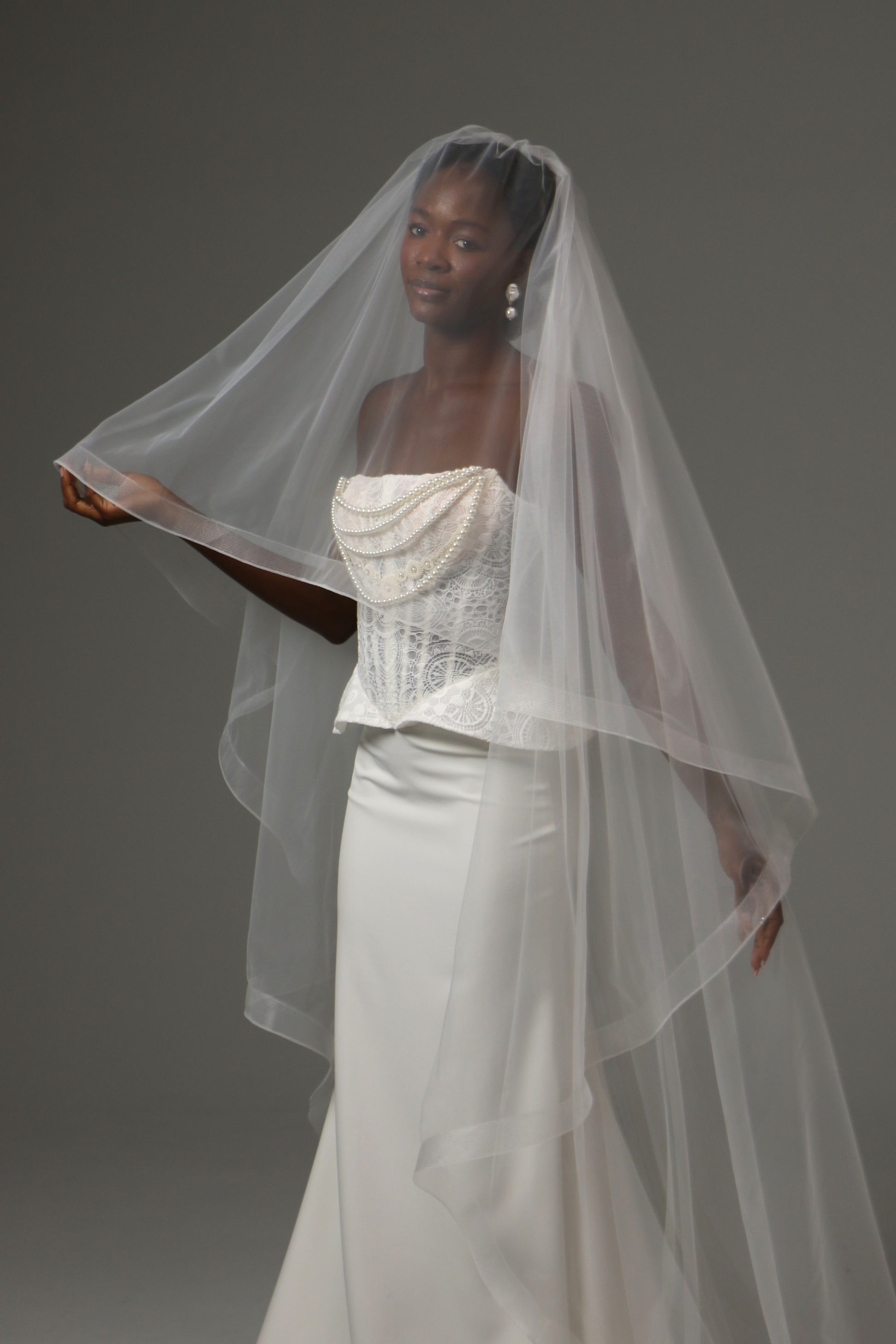 Cathedral-length wedding veil with elegant blusher layer.