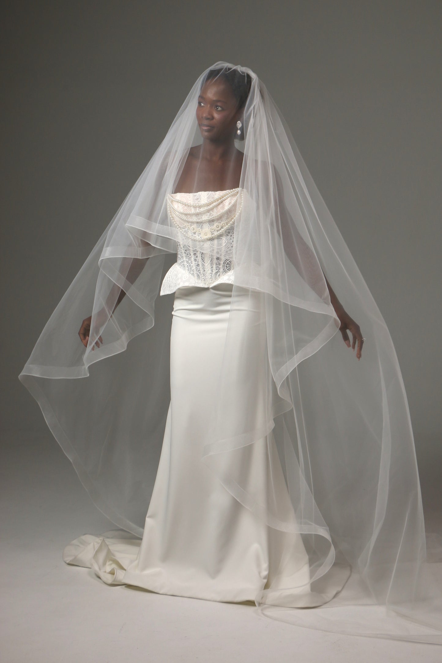 Lightweight wedding veil with structured horsehair border.