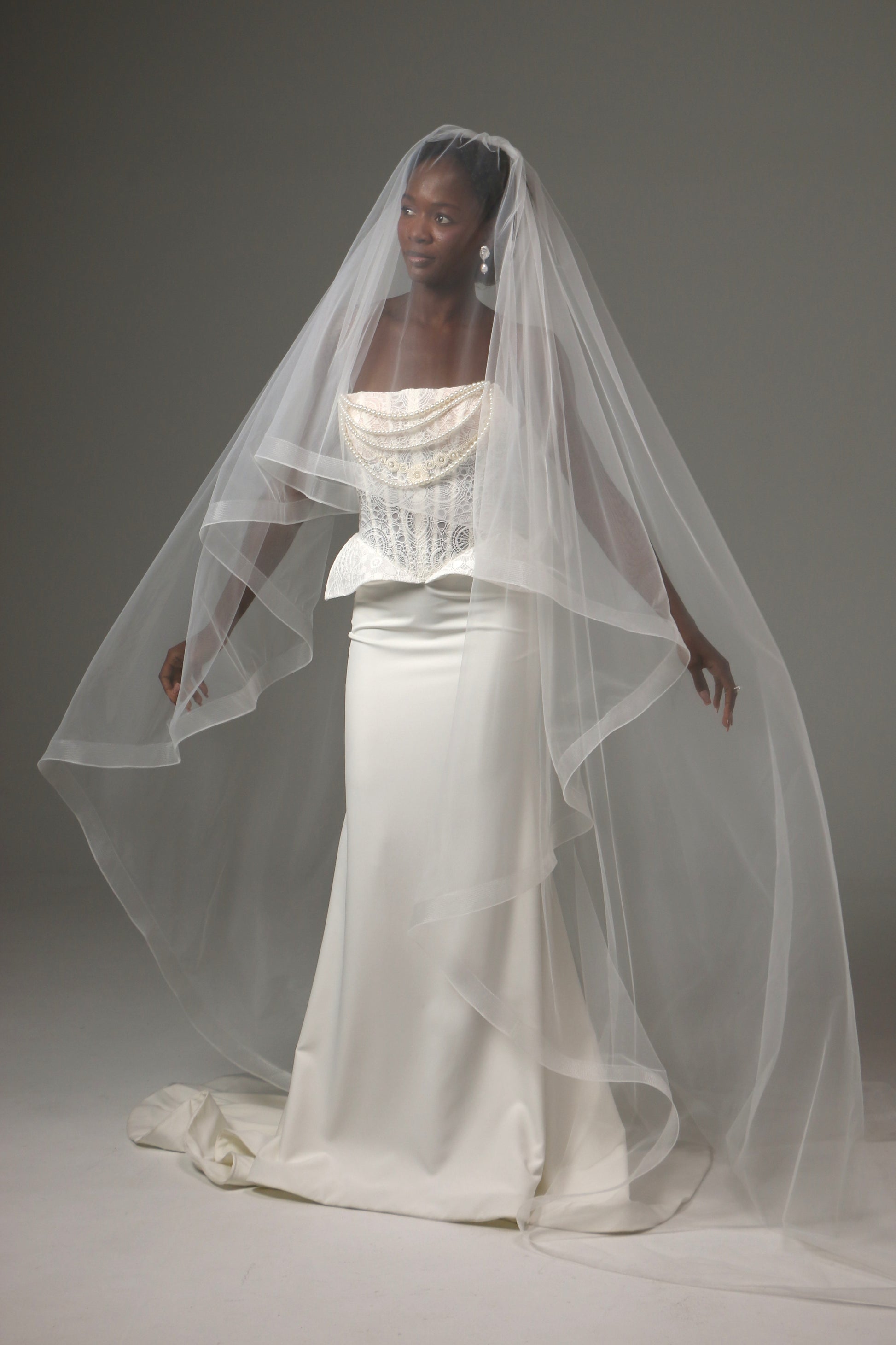 Lightweight wedding veil with structured horsehair border.