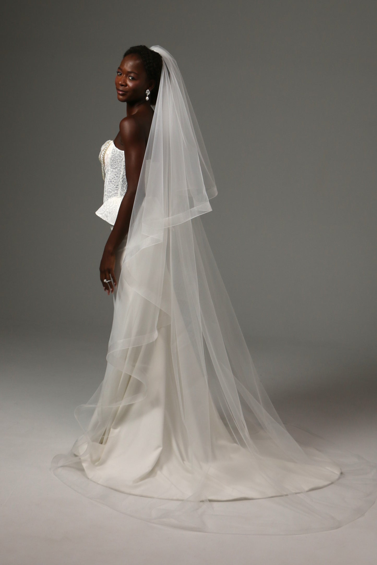 Elegant cathedral veil with dramatic volume and movement.