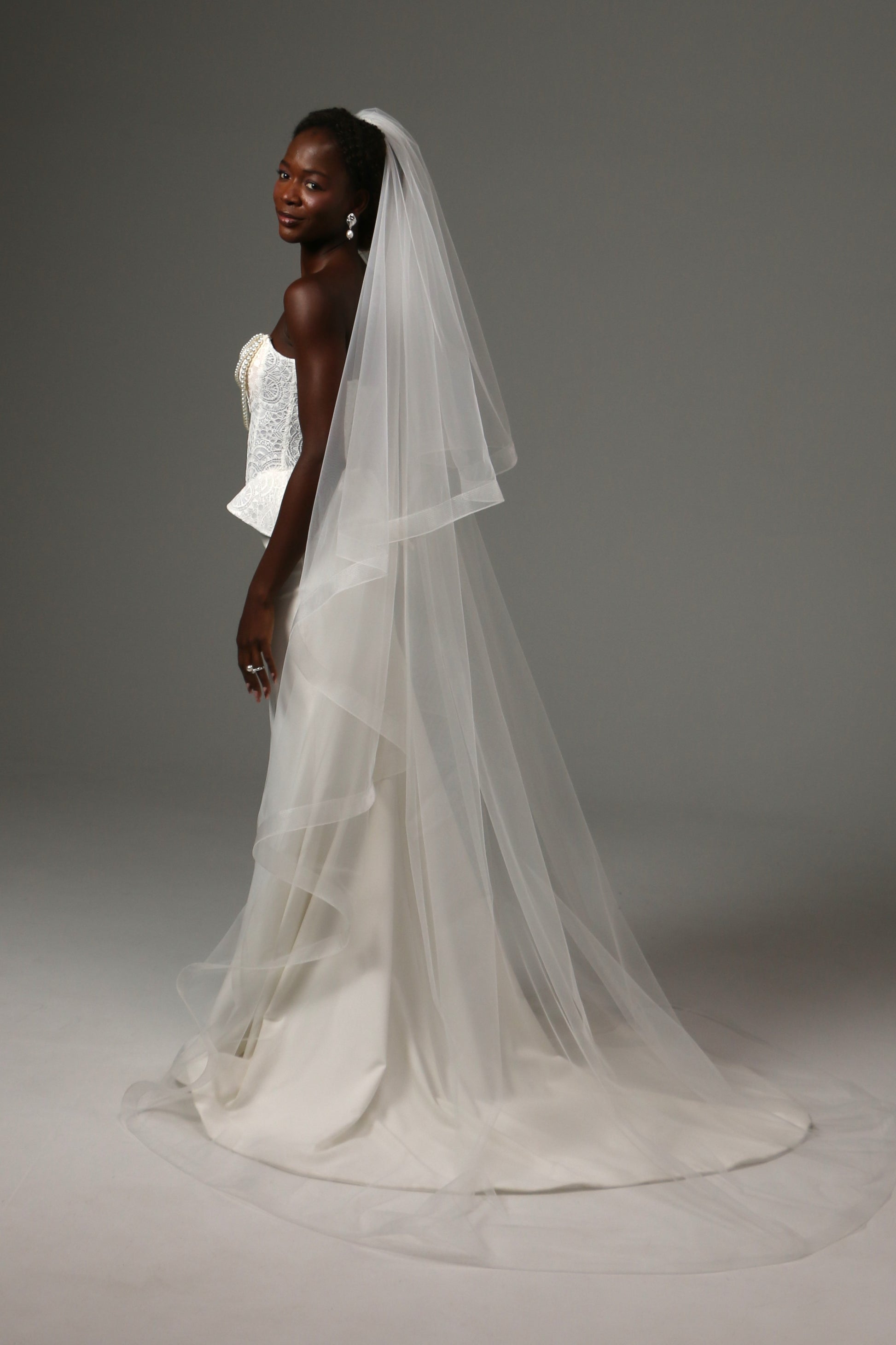 Elegant cathedral veil with dramatic volume and movement.