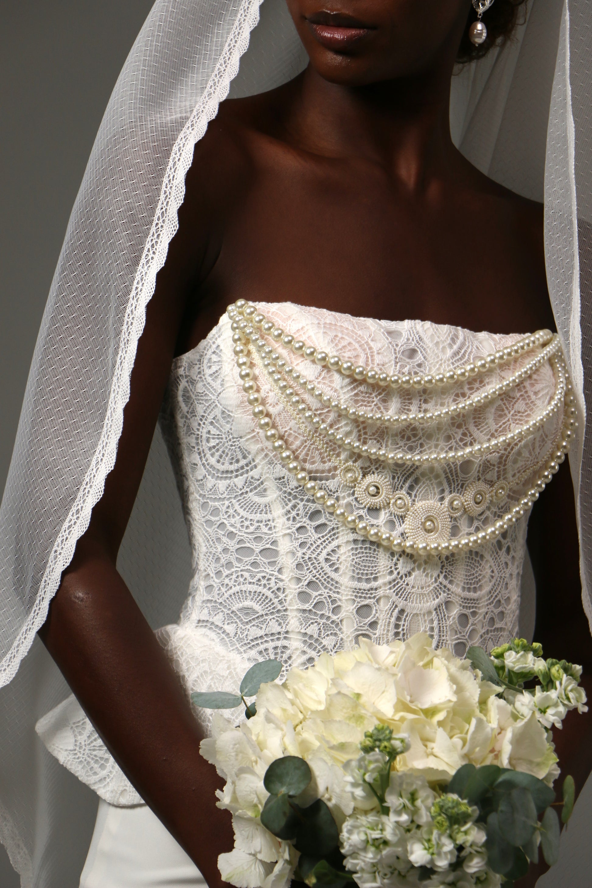 Soft dotted tulle veil creating a light and airy bridal silhouette.