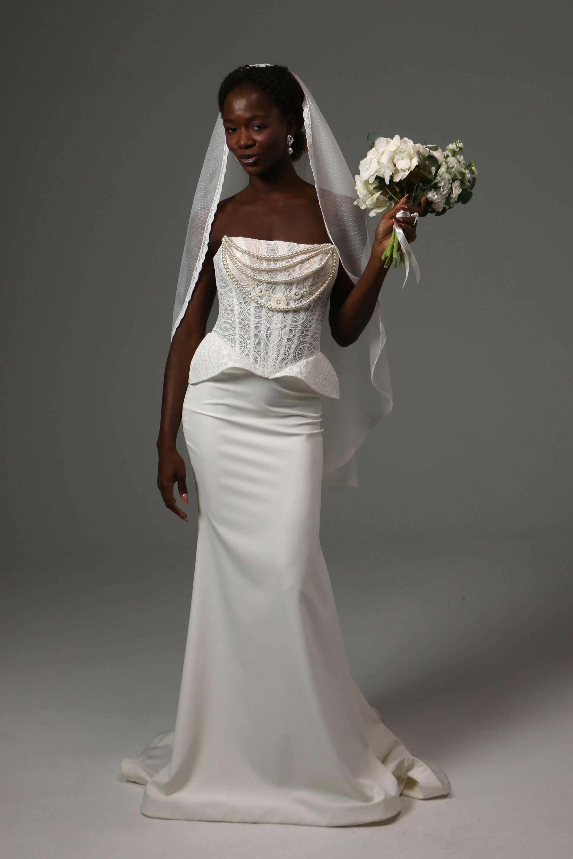 Romantic bridal veil featuring delicate lace trim and dotted texture.