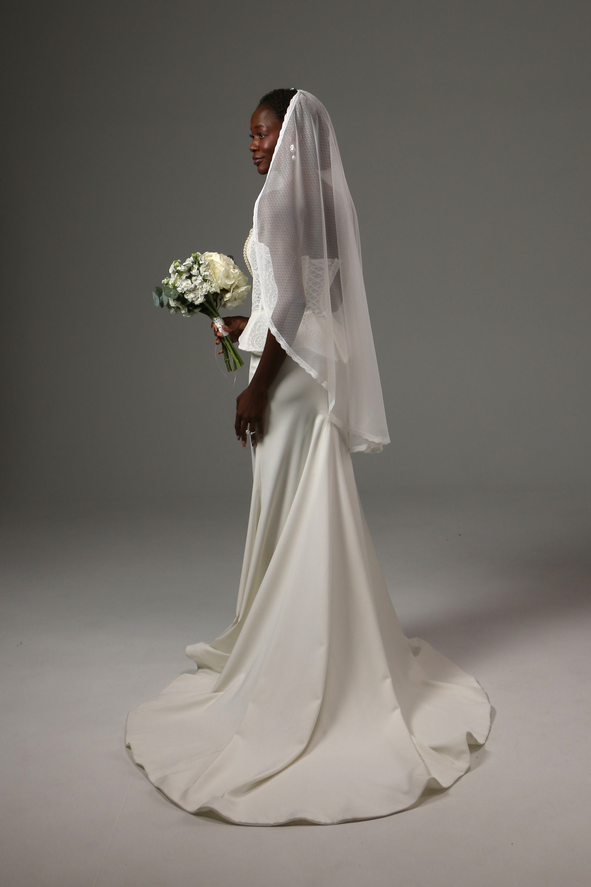 Romantic bridal accessory with soft drape and dotted texture.
