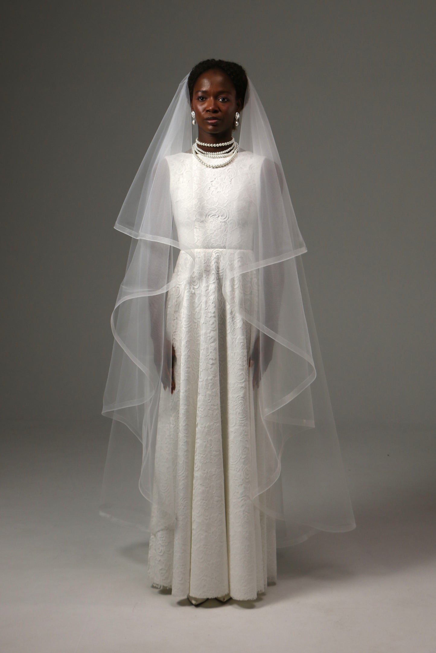 Two-tier waltz wedding veil with horsehair edge and blusher.