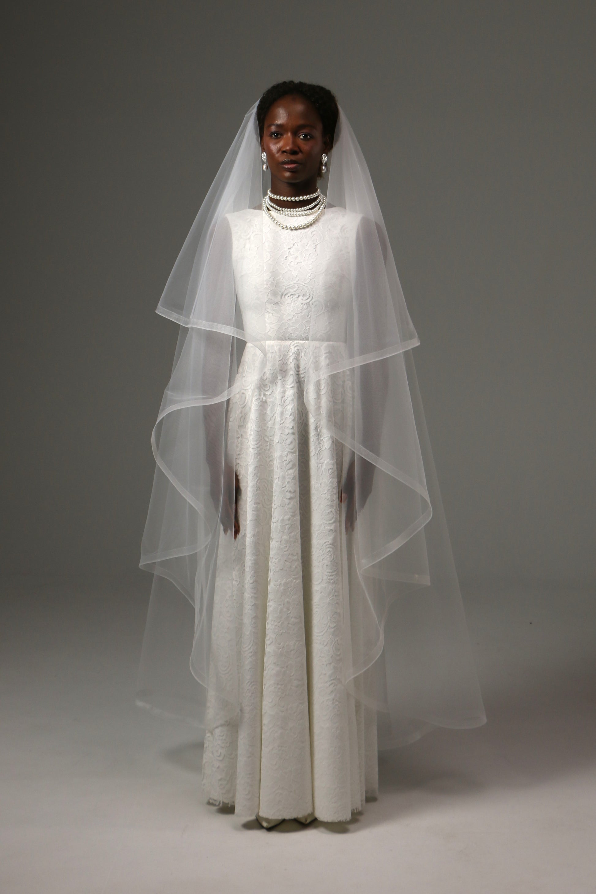 Two-tier waltz wedding veil with horsehair edge and blusher.