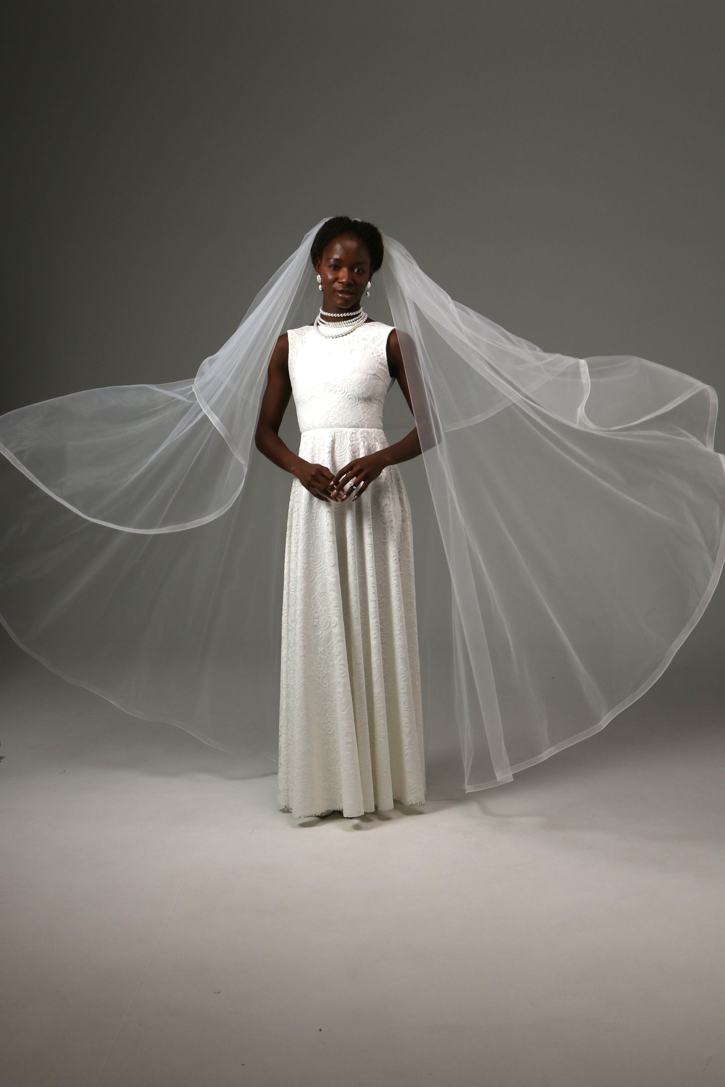 Waltz-length wedding veil creating graceful movement and volume.