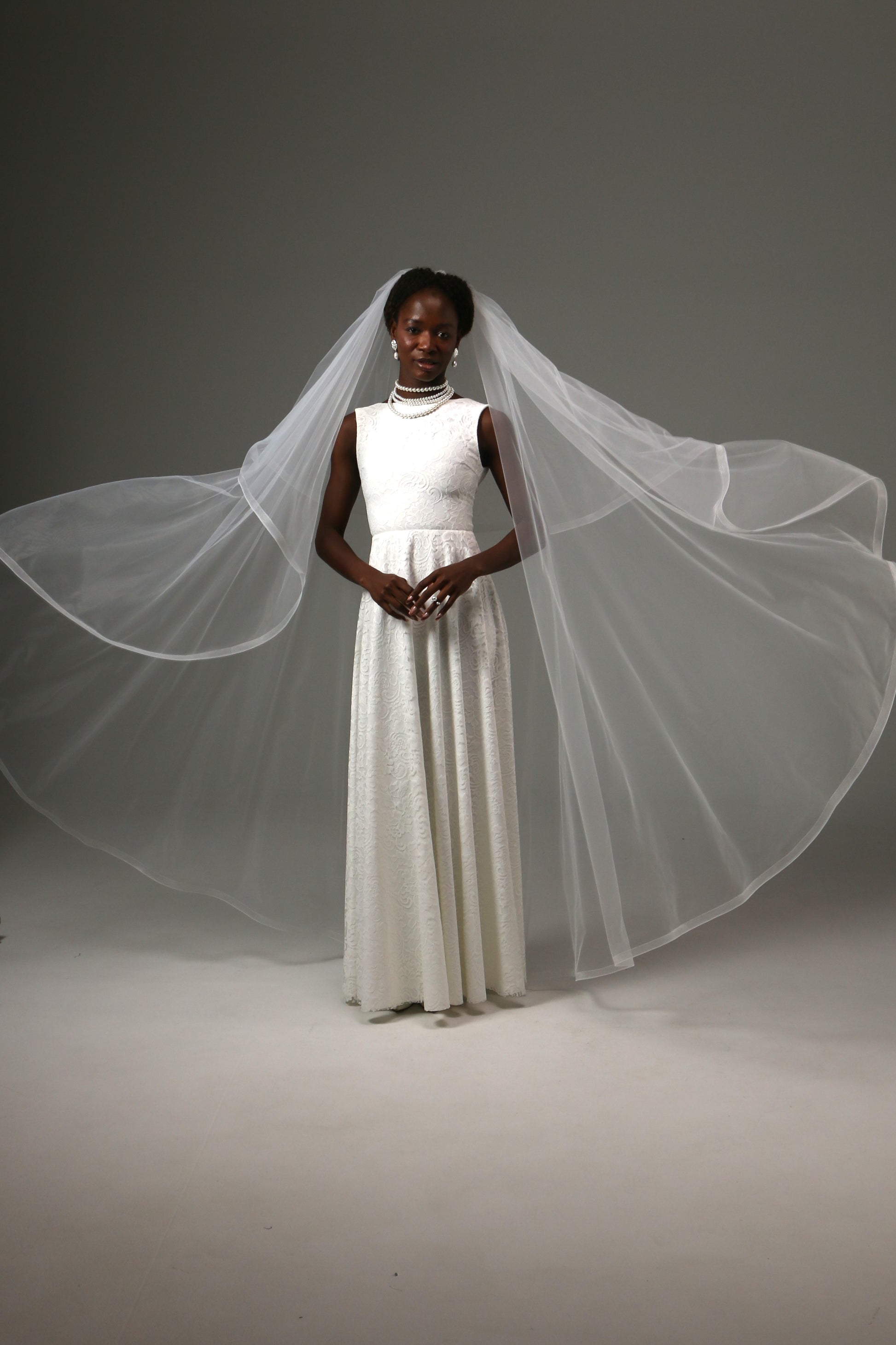 Waltz-length wedding veil creating graceful movement and volume.