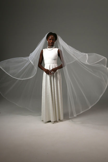 Waltz-length wedding veil creating graceful movement and volume.