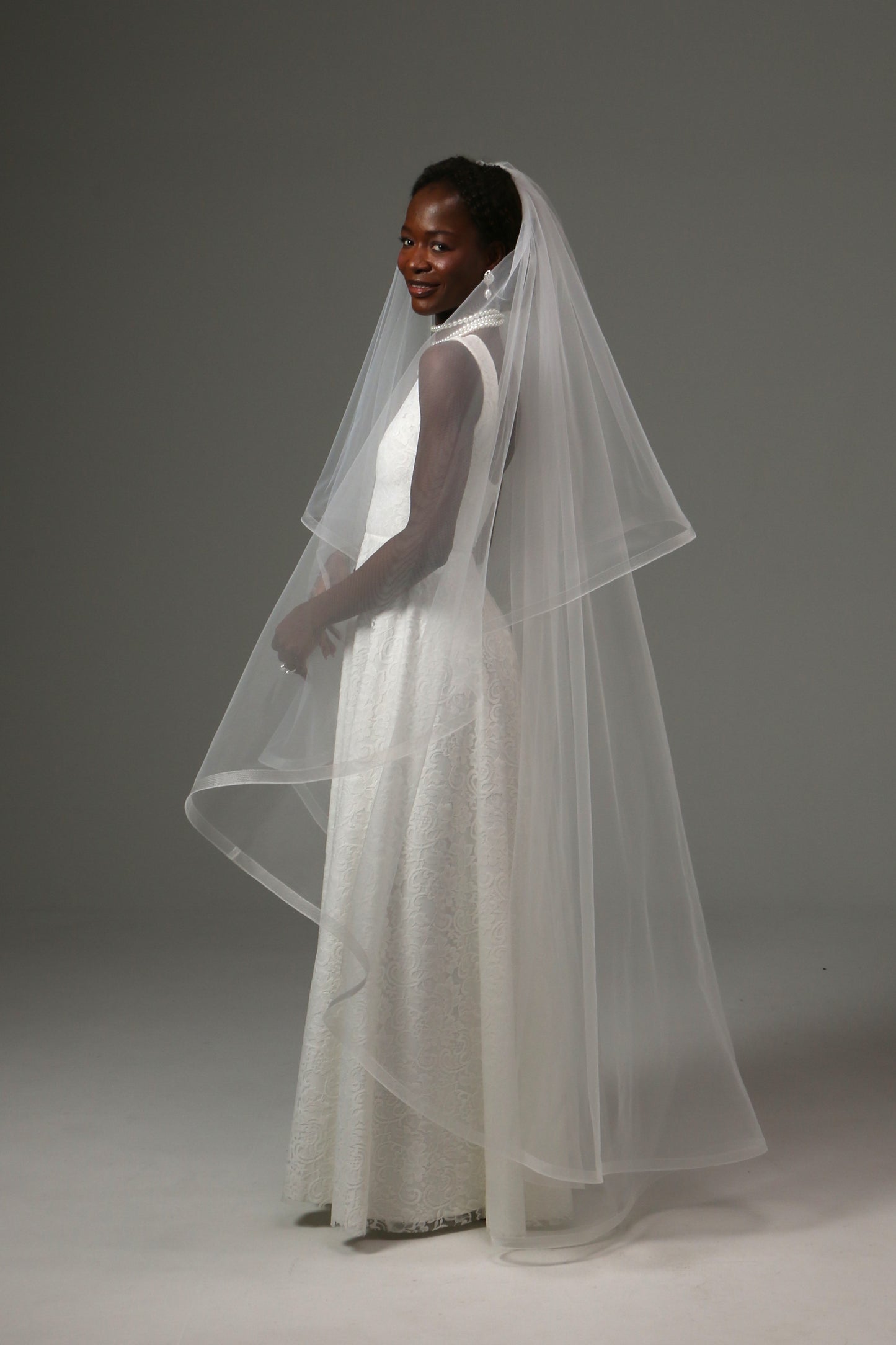 Two-tier wedding veil designed for romantic ceremonies.