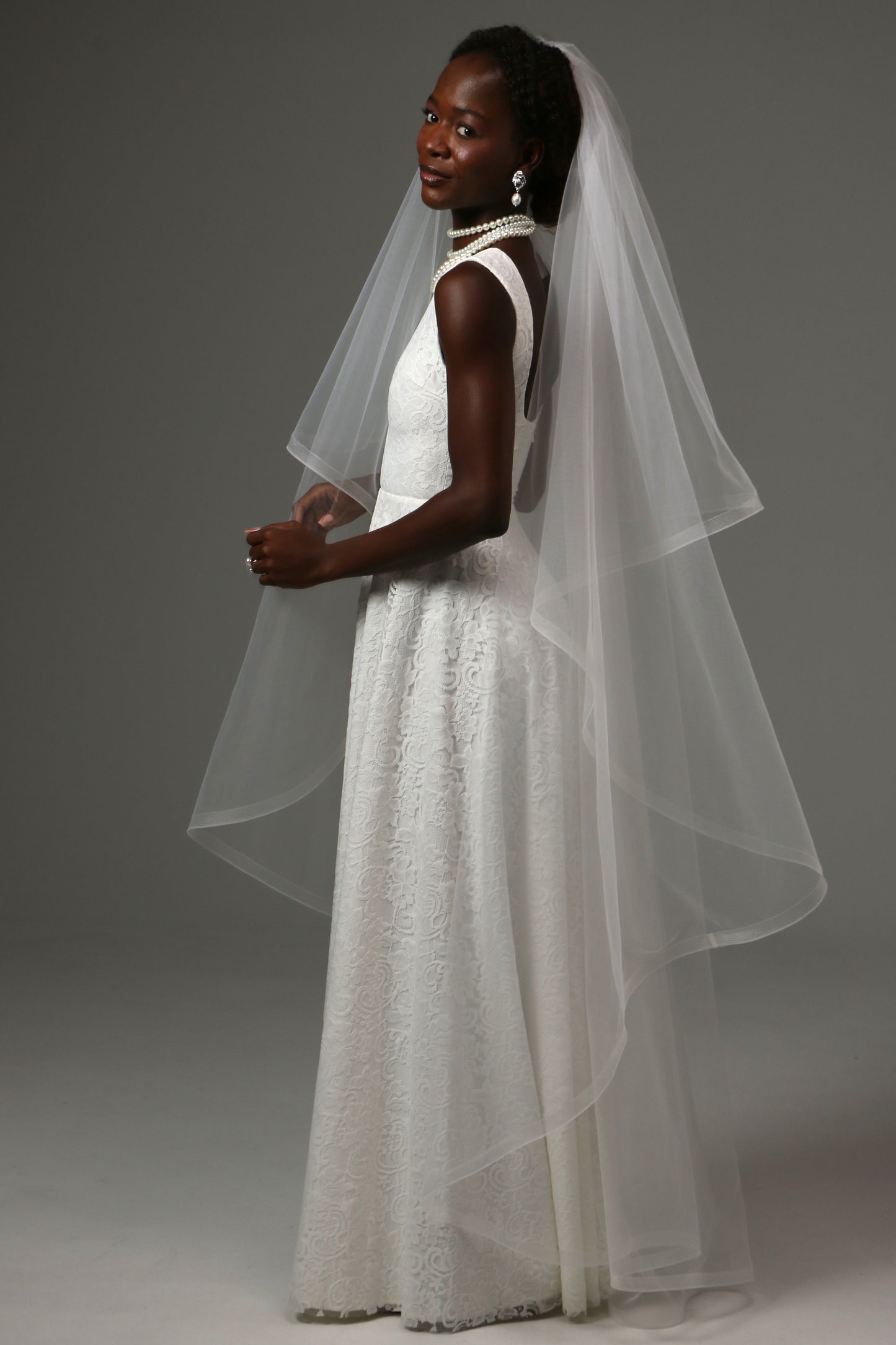 Horsehair-edged bridal veil paired with a classic wedding gown.