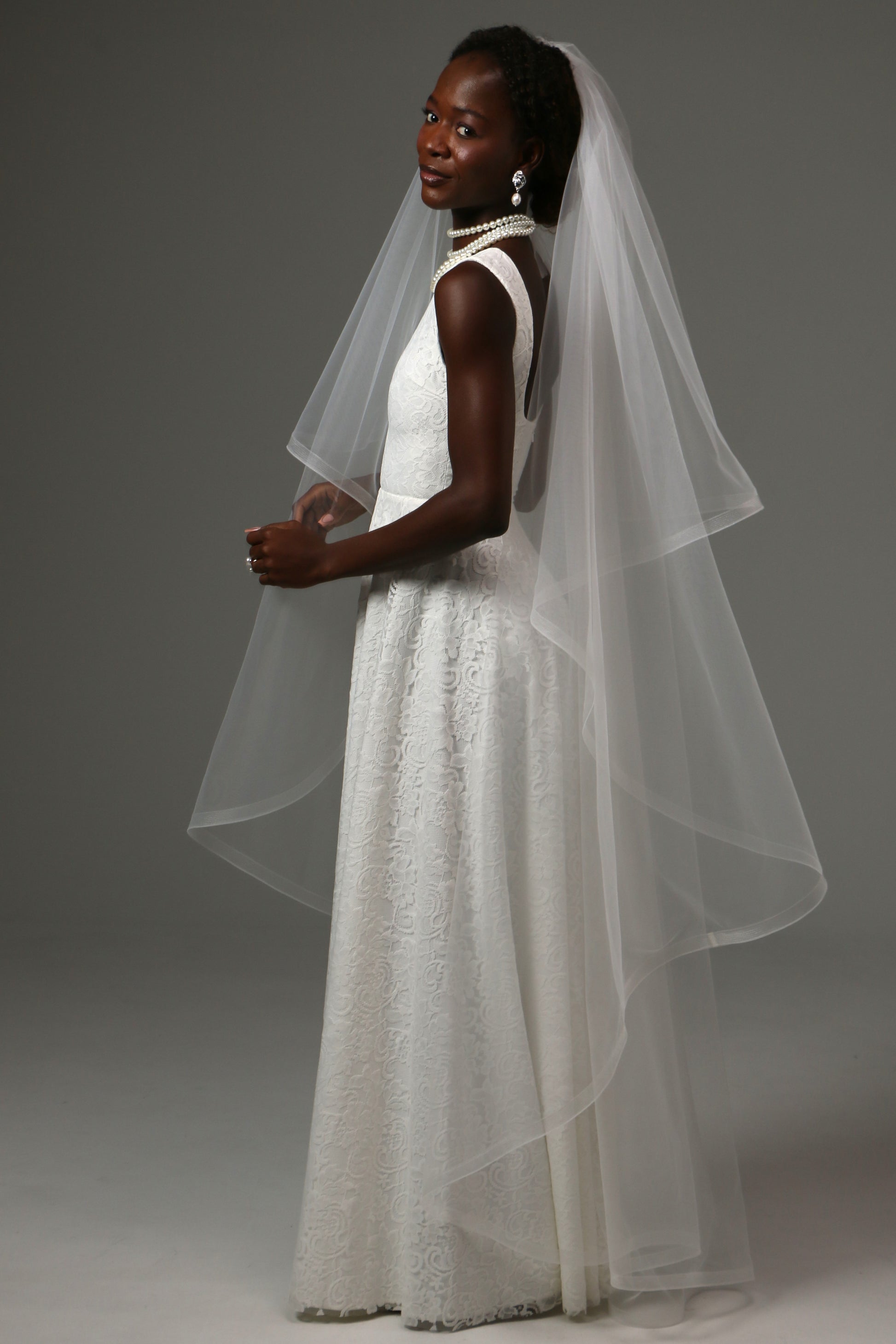 Horsehair-edged bridal veil paired with a classic wedding gown.