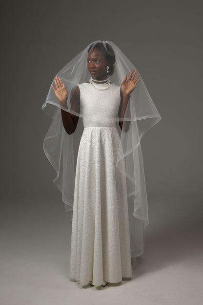 Modern bridal veil with structured edge and elegant drape.