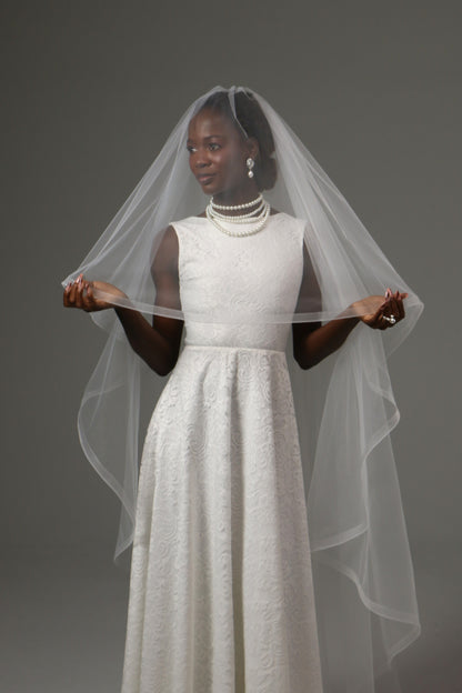 Waltz-length veil offering volume without cathedral length.