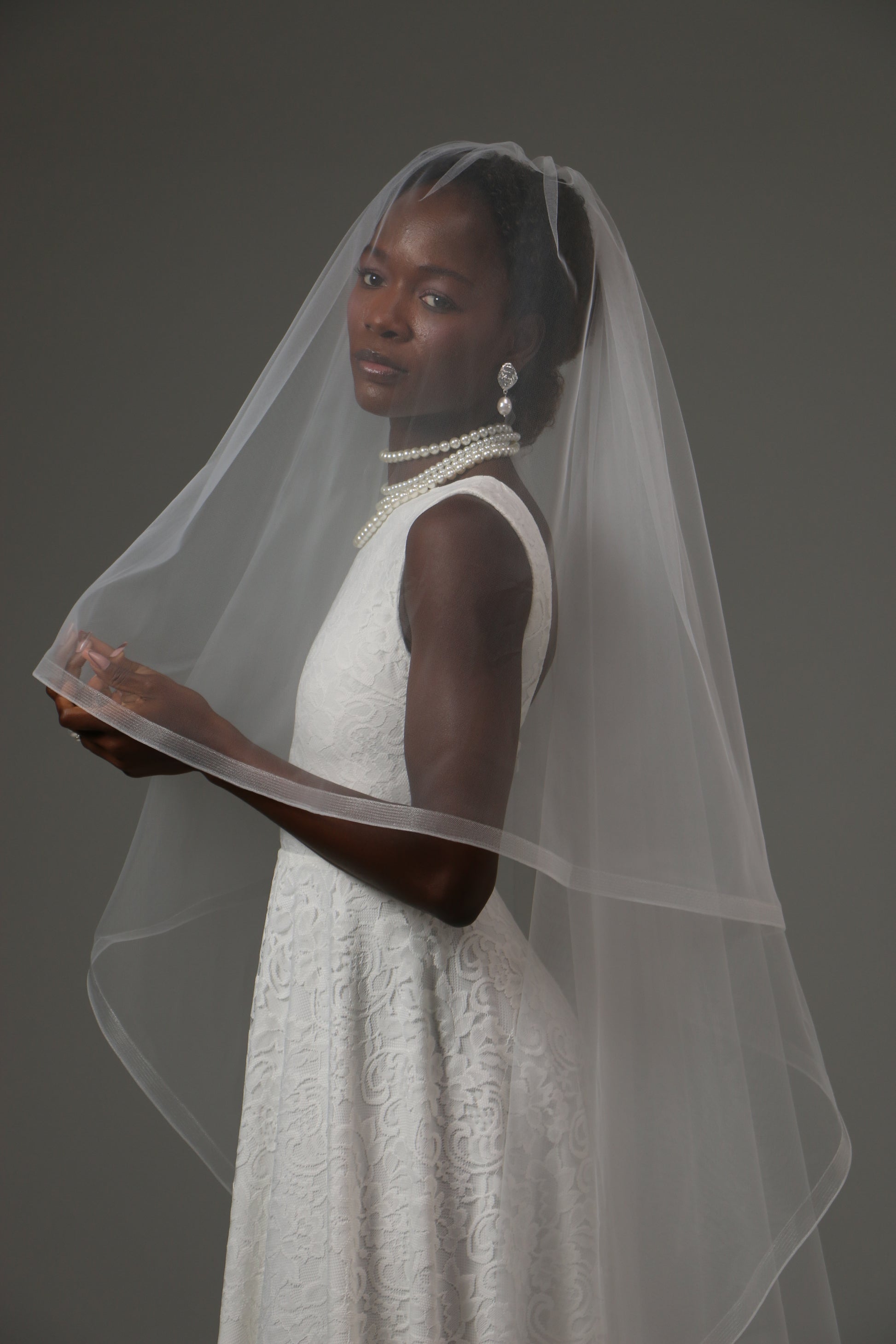Contemporary wedding veil with soft tulle and structured border.
