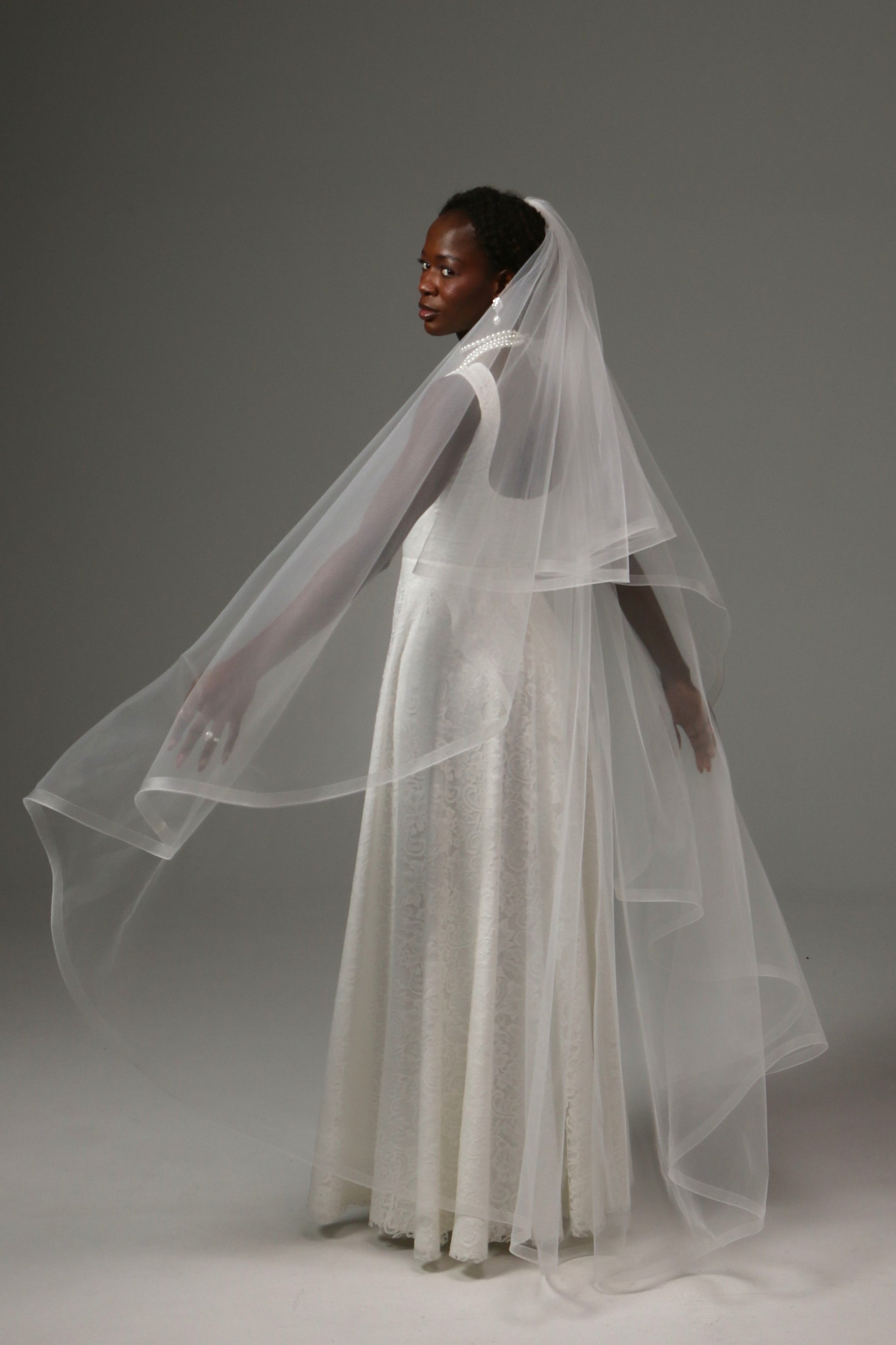 Waltz-length wedding veil with horsehair edge and blusher.