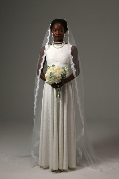 Bride wearing a one-tier mantilla veil crafted from soft tulle.