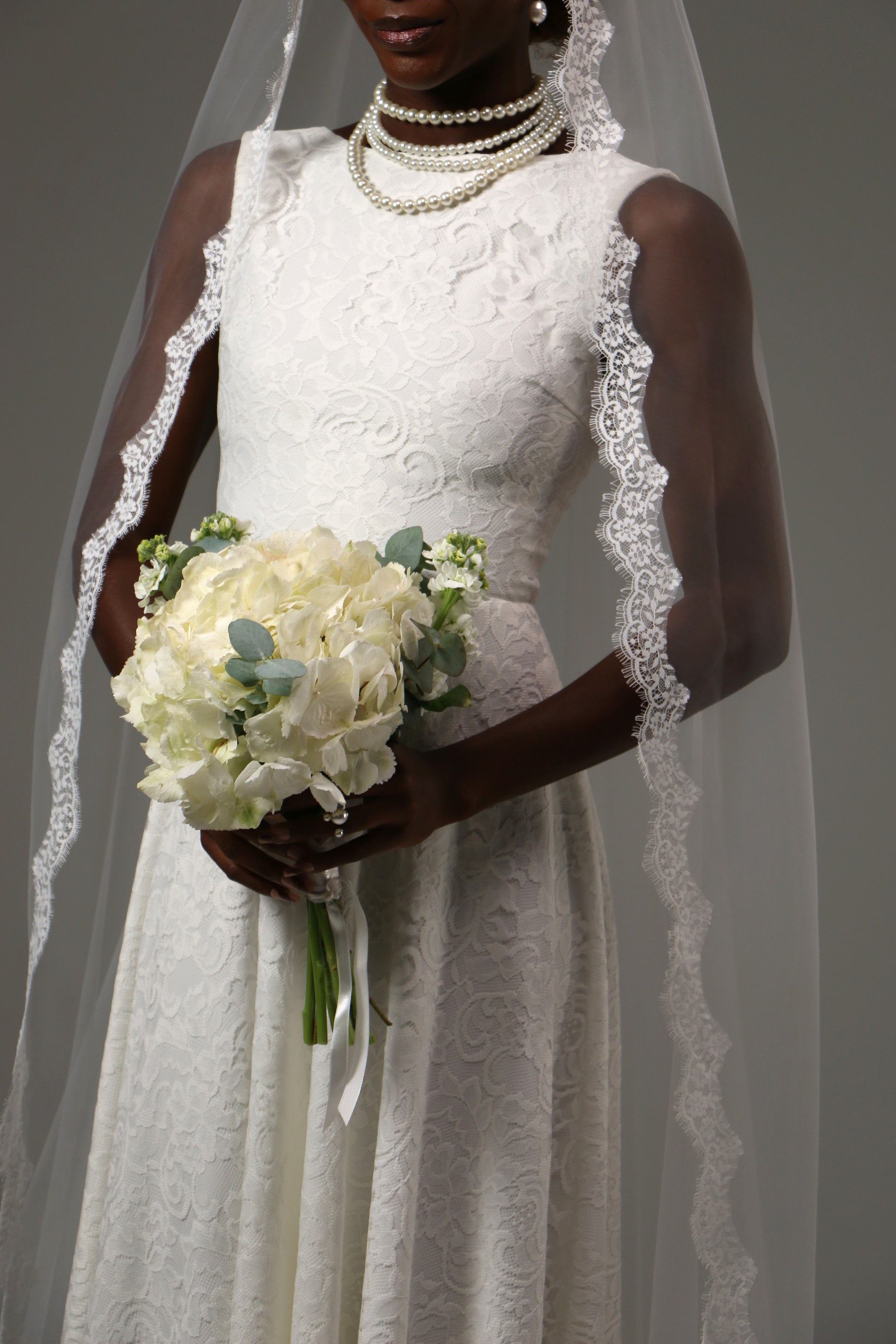 Romantic cathedral-length mantilla veil with floral lace edging.