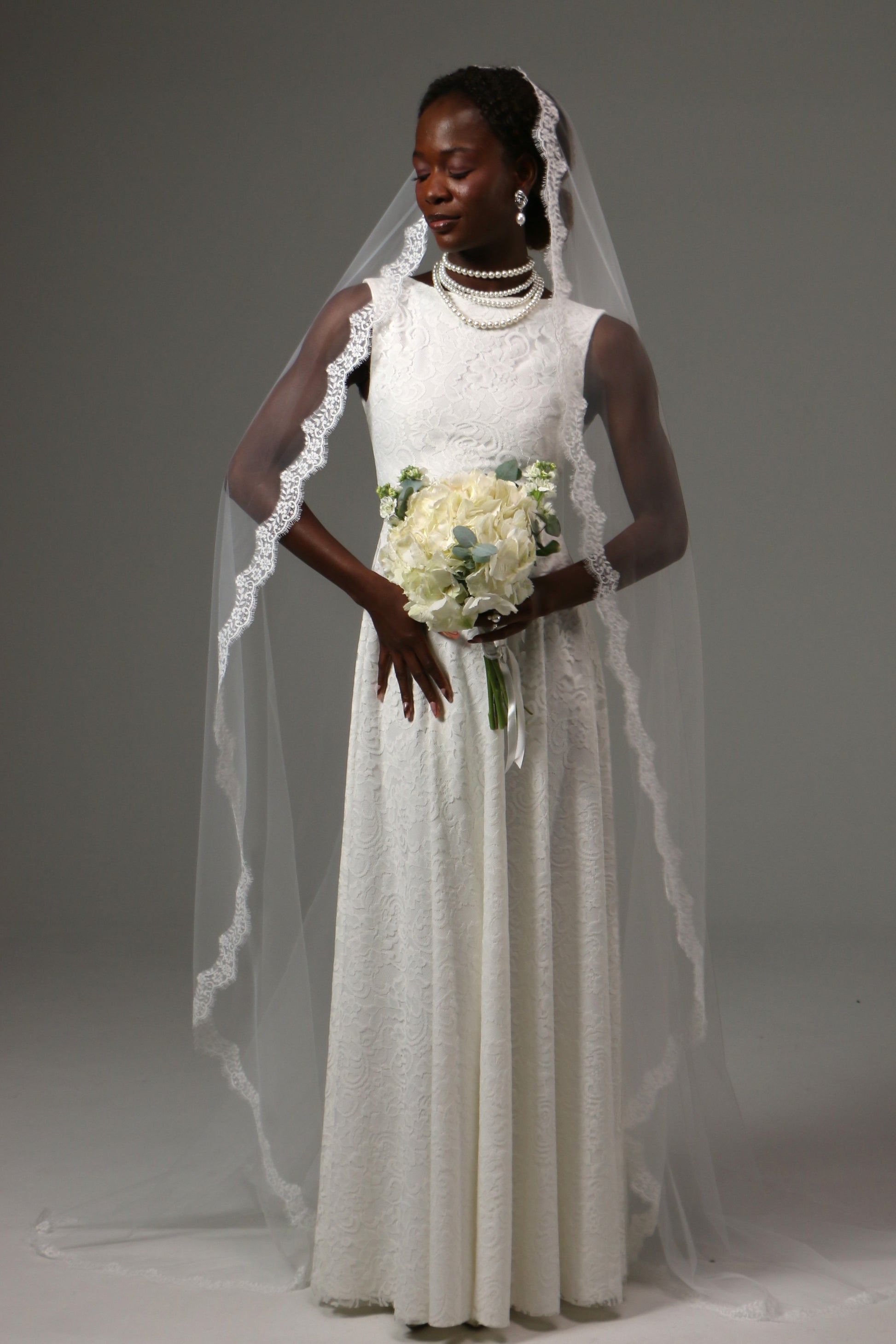 Cathedral mantilla wedding veil with delicate lace edge trim.