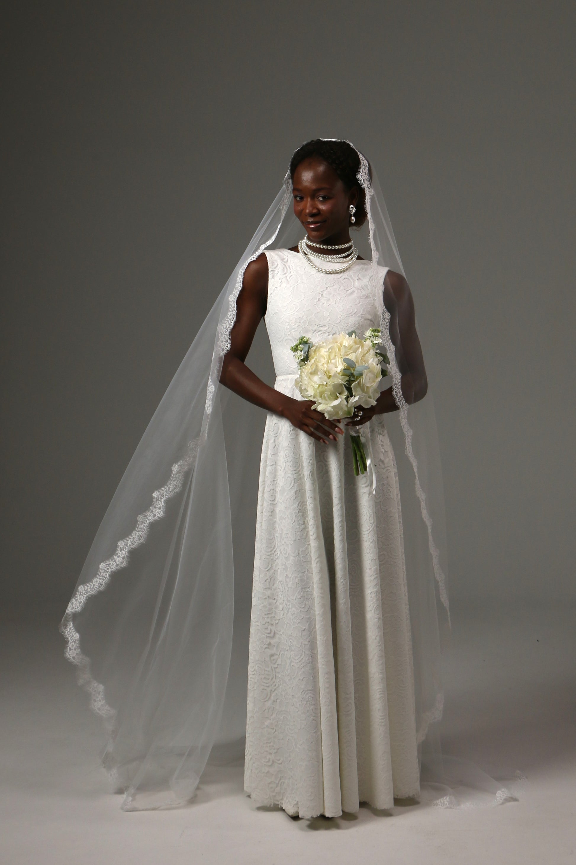 Lace-edged cathedral veil creating a romantic bridal look.