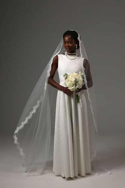 Lace-edged cathedral veil creating a romantic bridal look.