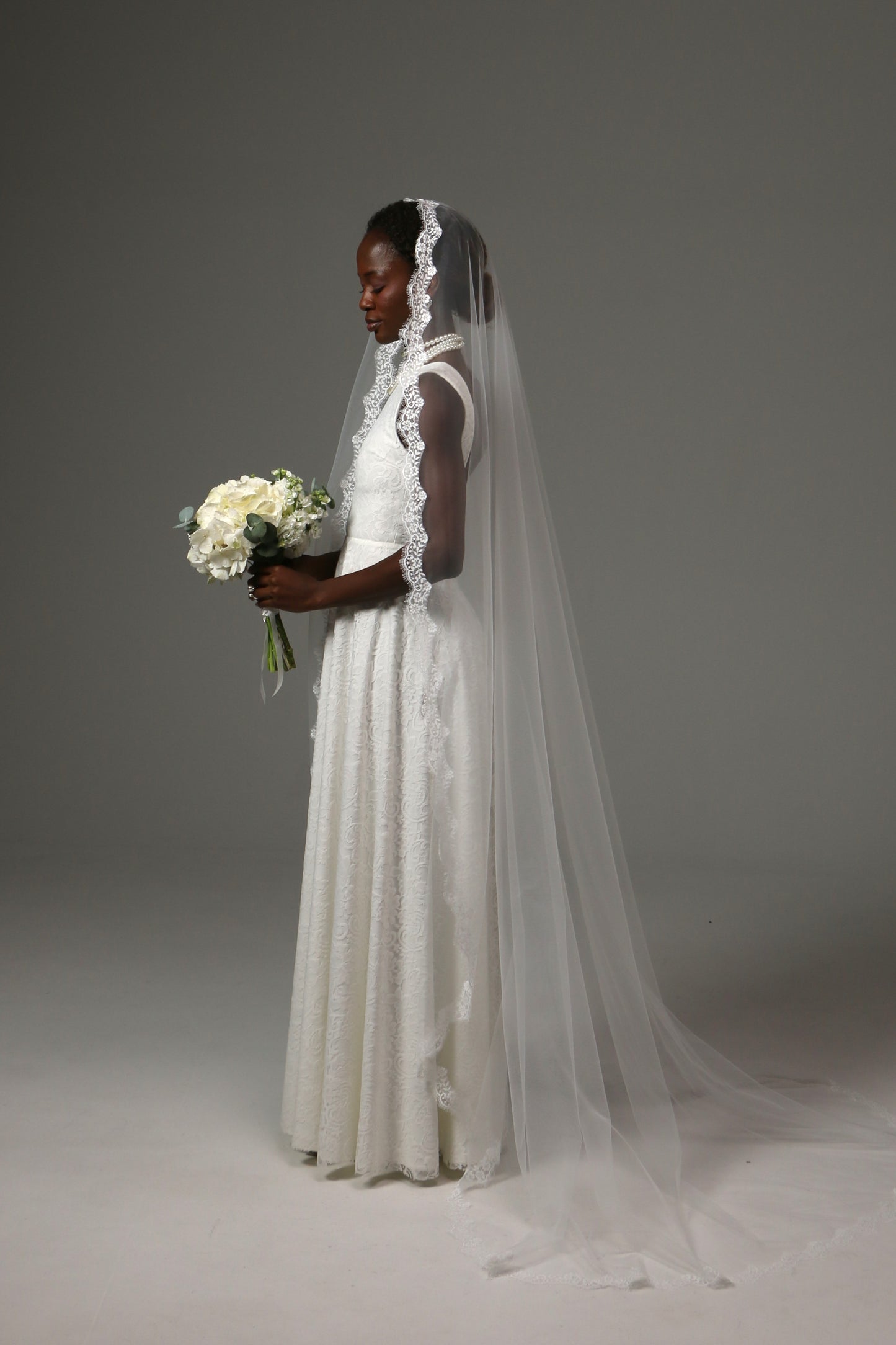 Timeless bridal accessory with soft illusion tulle and lace edge.