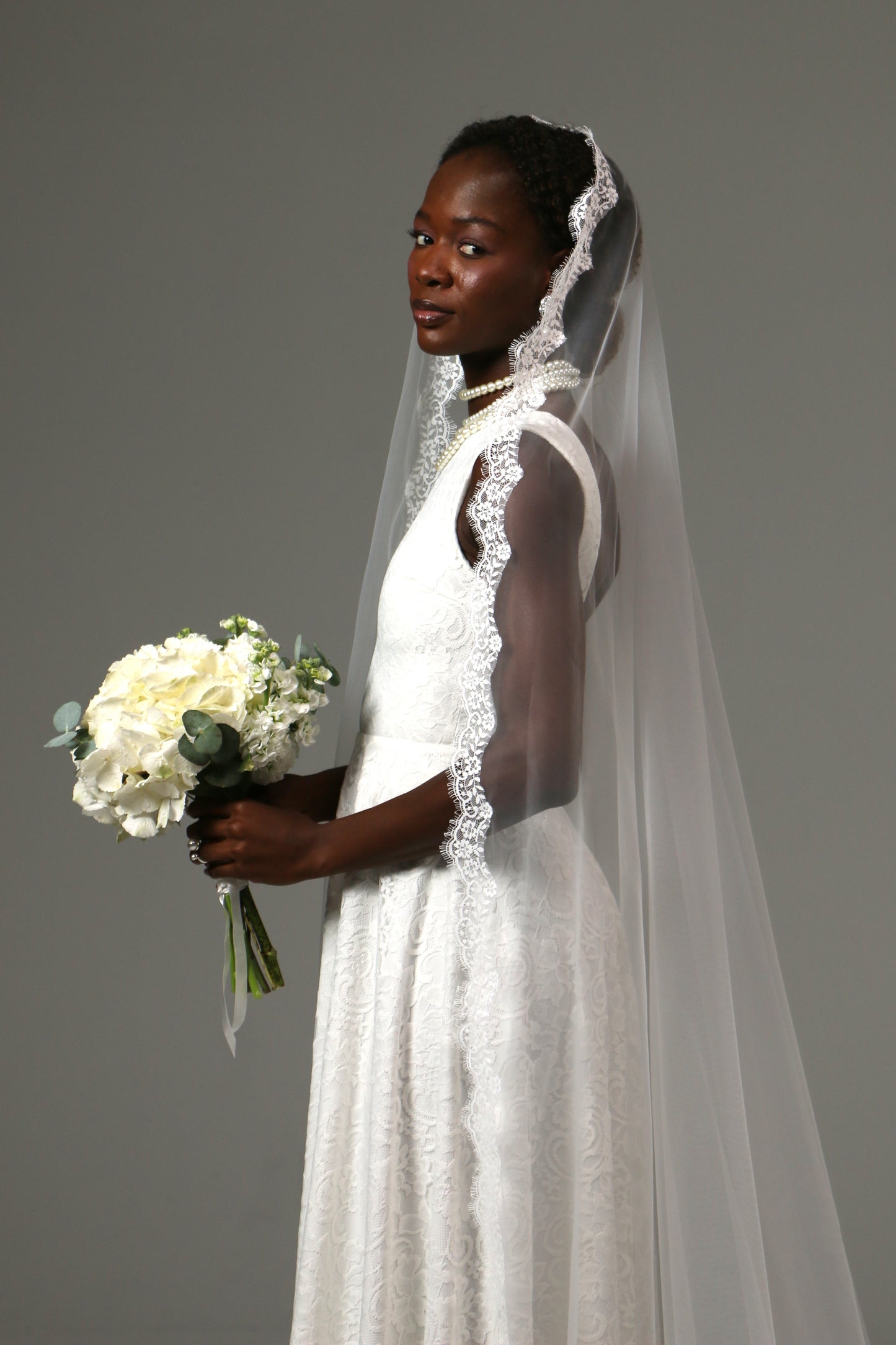 Soft tulle cathedral veil paired with a lace wedding dress.