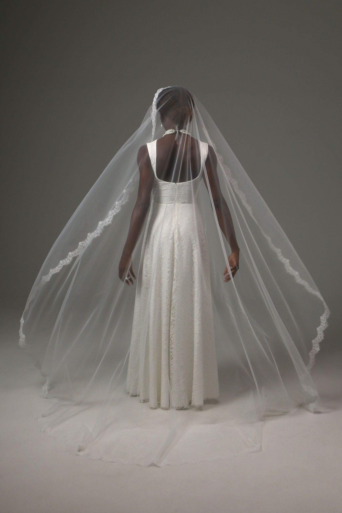 One-tier mantilla bridal veil with graceful flowing silhouette.