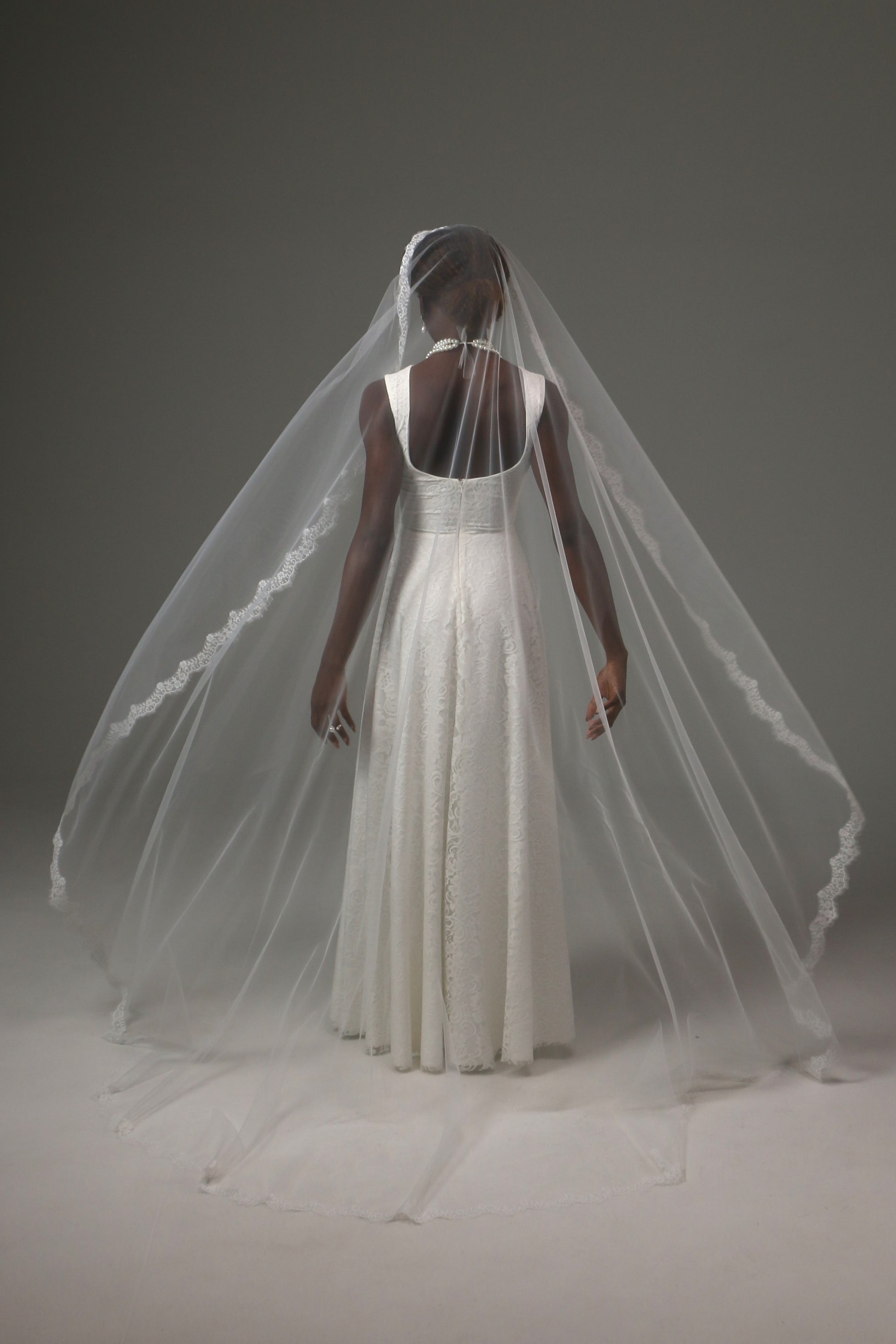 One-tier mantilla bridal veil with graceful flowing silhouette.
