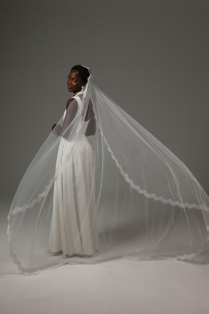 Elegant bridal veil draping naturally around a wedding gown.